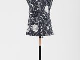 une robe noire et blanche posée sur un présentoir pour mannequin