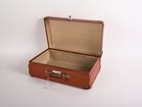 a brown suitcase sitting on a white surface