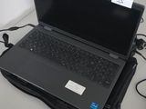 a laptop computer sitting on top of a desk next to a keyboard