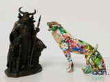 a statue of a bull and a statue of a man on a horse