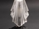 a glass figurine of a woman dressed in a wedding dress