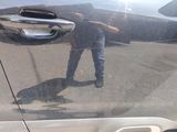 a reflection of a man in the side mirror of a car