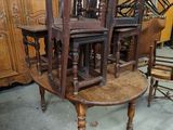 several chairs and a table are stacked on top of each other in a room