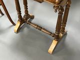 a wooden table with a marble top and two chairs