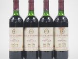 three bottles of wine are lined up on a white surface