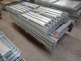 a lot of metal racks that are stacked up in a warehouse