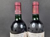 two bottles of wine sitting next to each other on top of a table
