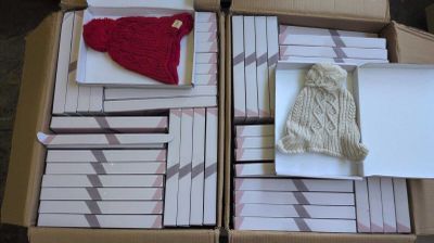 a box full of cards and a knitted hat in it