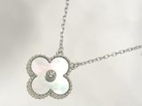 a close up of a necklace with a flower on a chain