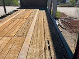 the back of a flatbed truck with a wooden deck