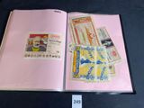 a pink book with stamps on it on a table