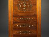 an old wooden cabinet with drawers and a clock on top