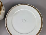 many plates and cups sitting on a table