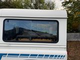 a white truck with a blue stripe parked in a parking lot