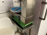 an image of a kitchen with a refrigerator and a chair