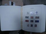 an open book with stamps on it sitting on a table