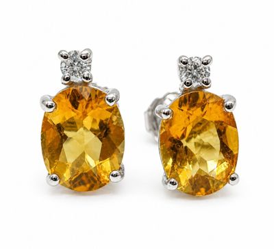 a pair of yellow sapphire and diamond earrings