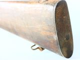 a very old gun that is sitting on a white surface