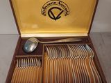 a wooden box with a set of silverware in it