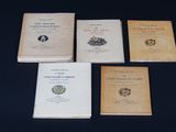 four books are sitting on a table with a black background