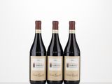 three bottles of wine sitting on top of a table next to each other