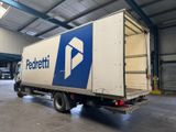 a delivery truck that is parked in a warehouse