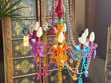 a colorful chandelier hanging from the ceiling in a living room