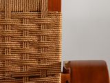 the back of a wooden chair with a woven seat and back rest