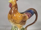a ceramic rooster that is sitting on a table