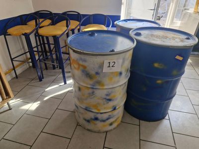 two blue barrels sitting next to each other on the floor