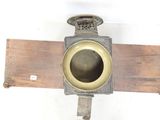 a small metal object on a piece of wood that is attached to a wall
