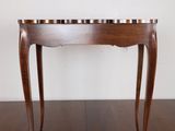 an image of a wooden table with a marble top on a wooden floor