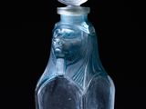 an image of a glass bottle with a bird on top