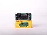 a green toy truck sitting on top of a yellow box