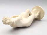 an image of a statue of a woman laying on her back