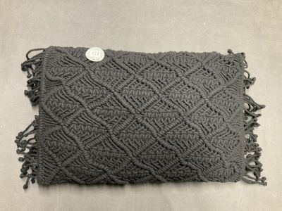 a close up of a gray pillow with a button on it