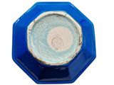 a close up of a blue and white plate on a white background