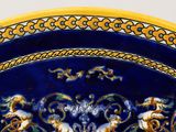 a blue and yellow plate with a picture of angels on it