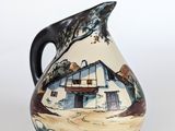 a picture of a ceramic pitcher with a house painted on it