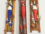 three wooden toy boats on display on a white surface