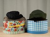 two hats that are sitting in a box on a table
