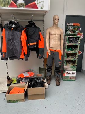 a mannequin of a man standing in front of a display of clothing