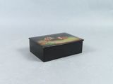 a small black box with a painting on it