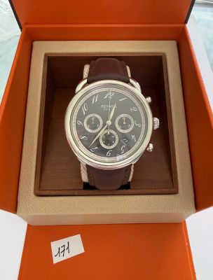 an orange box with a watch inside of it sitting on a table