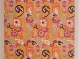 an orange and pink wall hanging with a pattern on it
