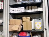 many boxes and containers on the shelves in the room