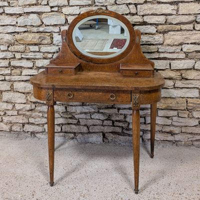 a small wooden vanity with a mirror on top of it