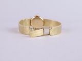 a close up of a gold watch on a white background
