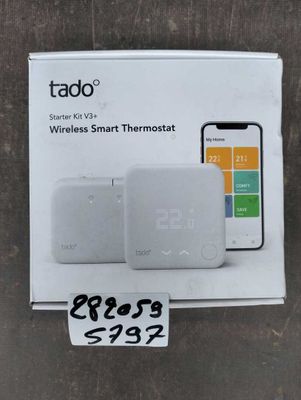 a white box with a phone and a smart thermosta on top of it