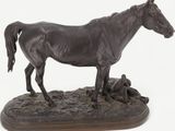 a statue of a horse that is standing on a rock
